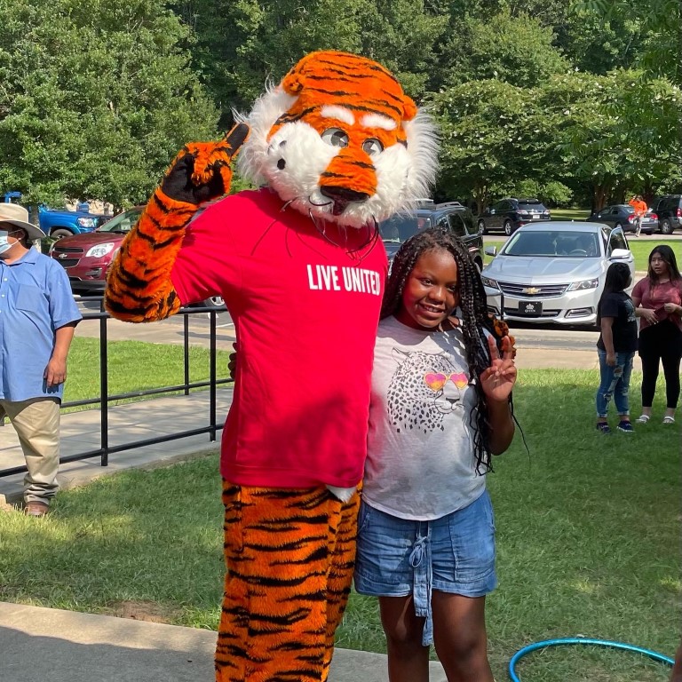 Aubie and a girl posing
