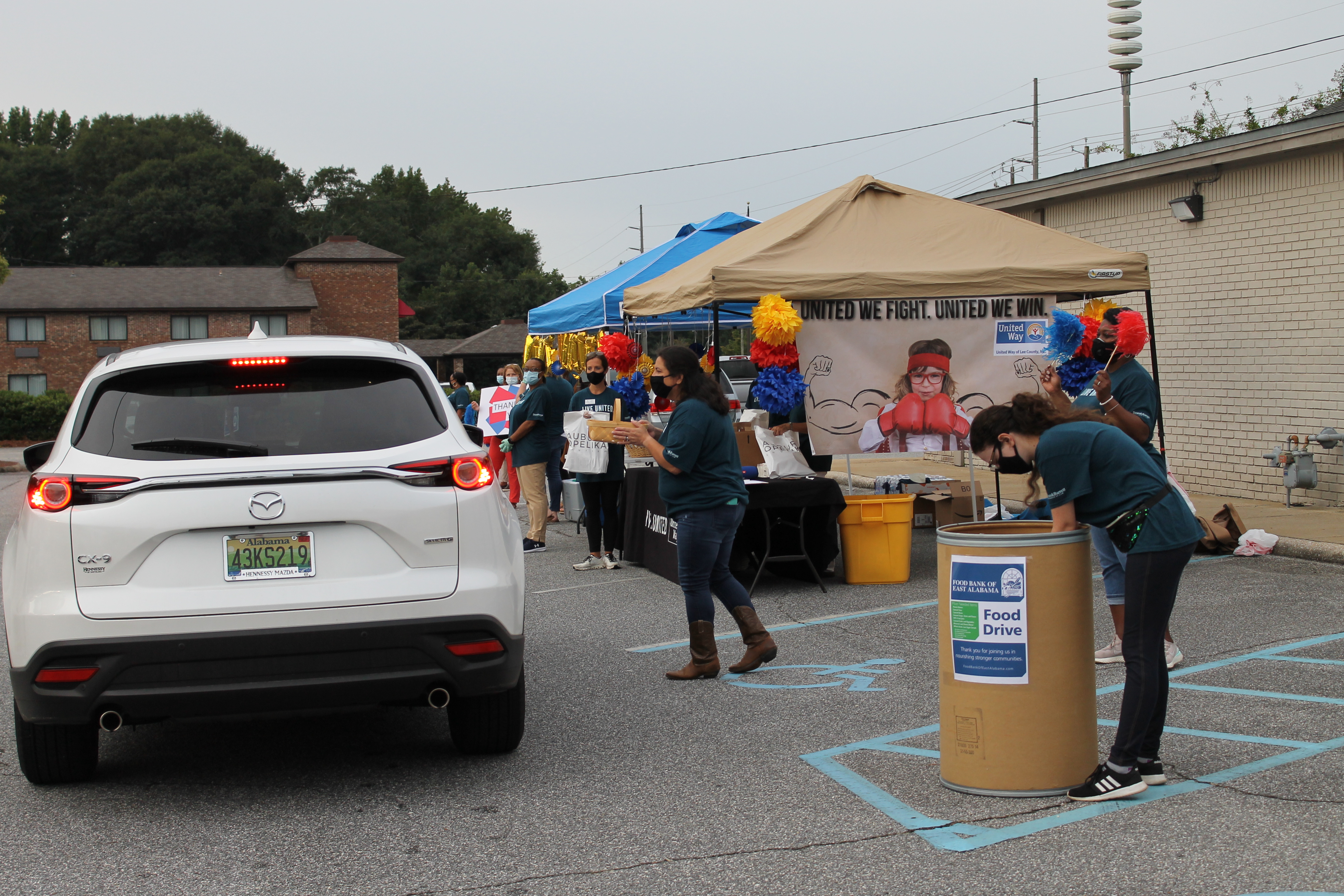 Car going through the line to donate canned goods and pickup breakfast