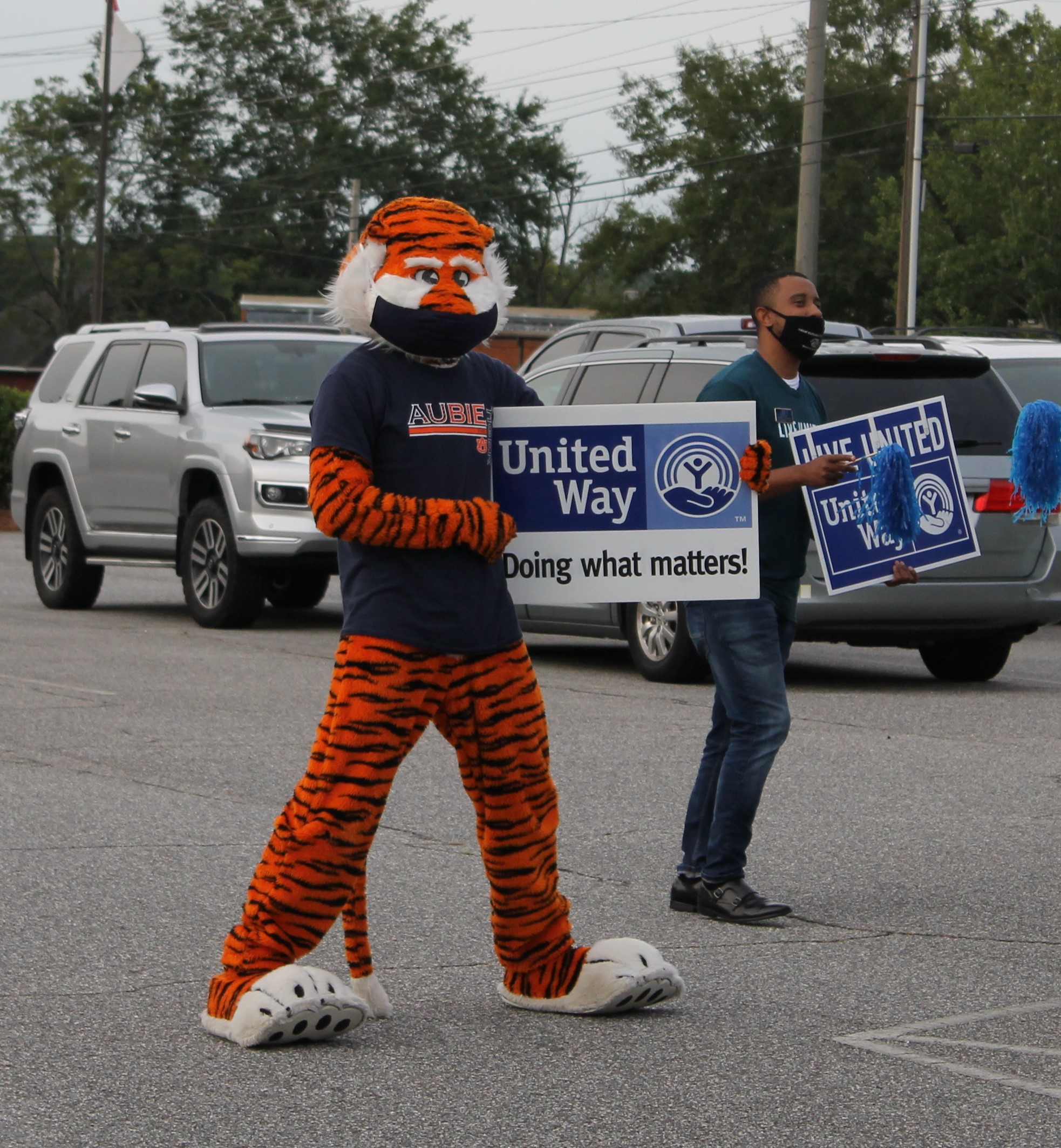 Aubie holding a live united sign