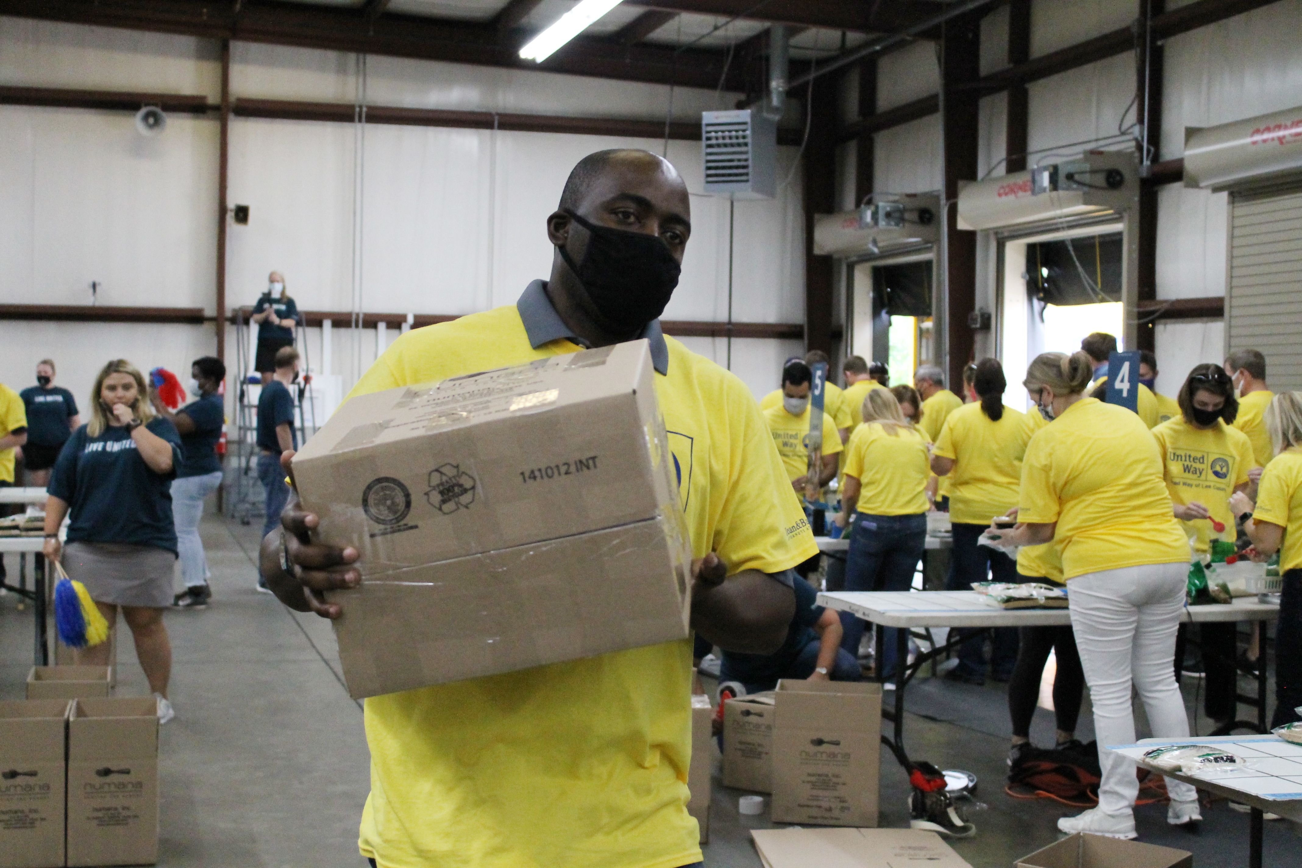 Volunteer carrying a box of food