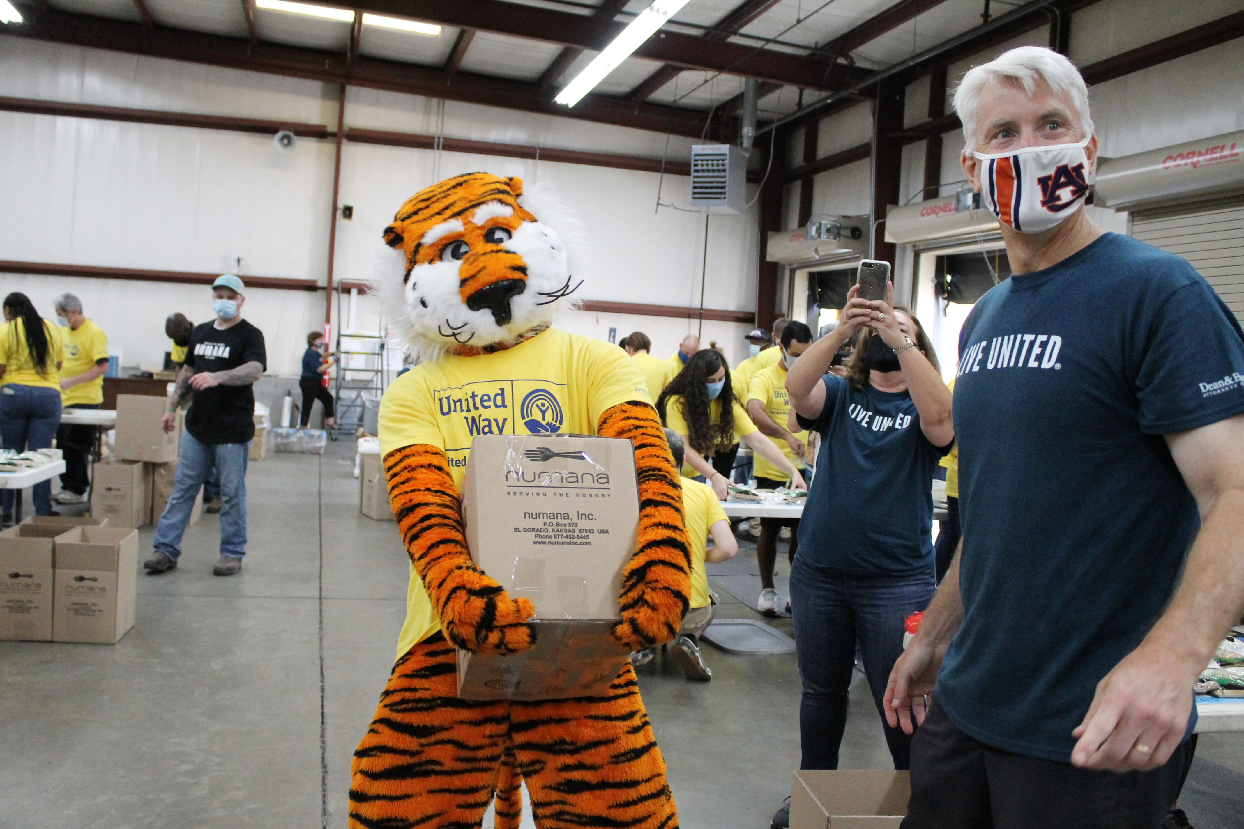 Aubie carrying a completed box of meals